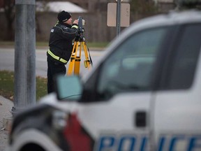 Windsor police traffic collision specialists examine the scene of an overnight crash on McHugh Street near the WFCU Centre on the morning of Nov. 20, 2017.