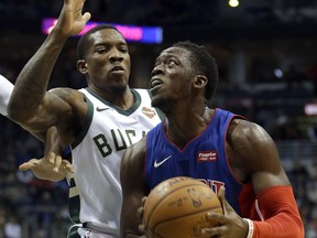 Detroit Pistons' Reggie Jackson looks to shoot against Milwaukee Bucks' Eric Bledsoe during the first half of an NBA basketball game, Nov. 15, 2017, in Milwaukee.