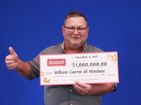 William Currie of Windsor holds up his prize cheque for $1 million, which he won playing the Instant X Money scratch game.