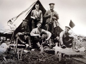 Pte. Lawrence Johnson, centre, is shown relaxing with fellow soldiers during the First World War. It is one of several photos, letters and medals he kept in a box that now belongs to his daughter Marie Harvey and her husband, Vern Harvey, of Windsor. Johnson, who died in 1970, fought in the Battle of Passchendaele.