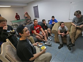 In this file photo, a group of boys watch television at the grand opening of the new location of the LaSalle Hangout for Youth, Feb. 18, 2017.