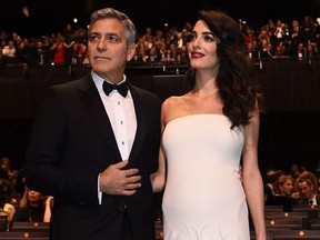 US actor George Clooney (L) and his wife British-Lebanese lawyer Amal Clooney pose as they arrive for the 42nd edition of the Cesar Ceremony at the Salle Pleyel in Paris on February 24, 2017. (BERTRAND GUAY/AFP/Getty Images)