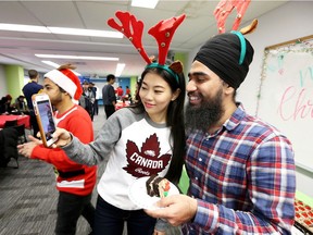 University of Windsor international students Lan Ma, left, of China and Harleen of India, take a selfie while enjoying cake and camaraderie during a Christmas Party at the International Student Centre at Laurier Hall Dec. 8, 2017.  Ma said Chinese people celebrate Christmas but not to the same extent as in North American.