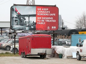 A billboard on Tecumseh Road West near Crawford Avenue on Dec. 7, 2017, calls for a better contract for Canada Border Services Agency officers.