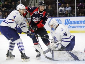 Mississauga Steelheads goalie Emanuel Vella smothers the puck with Igor Larionov of the Windsor Spitfires closing in on Friday in Mississauga's 3-2 win over Windsor at the Hershey Centre. (Photo credit to Iain Colpitts of Mississauga News).