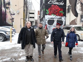 Downtown Windsor BIA chair Larry Horwitz, left, Barry Horrobin, police director of planning and physical resources, Const. Andrew Drouillard, and Sarah Cipkar of the Downtown Windsor Community Colaborative walk along on Maiden Lane on Dec. 13, 2017 after the announcement of funding for a four-phase alley enhancement project.