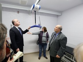 Windsor Mayor Drew Dilkens, left, and Coun. Ed Sleiman tour the new family-accessible washroom at Gino and Liz Marcus Community Complex, Dec. 15, 2017. City of Windsor accessibility and diversity officer, Gayle Jones, displays a human lift and adult change table, part of the project.