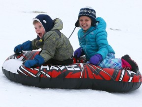 Brody Tynkaluk, 3, left, and his sister Brooke Tynkaluk, 6, have a blast taking their Havoc snow tube down the toboggan hill at Little River Park on Sunday, Dec. 17, 2017.  Watching nearby was their grandmother, Nana Paula Tynkaluk.
