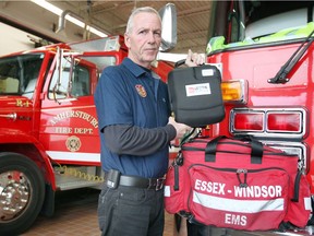 In this Dec. 21, 2017 photo, Amherstburg Fire Chief Bruce Montone displays a defibrillator which is carried in the 'trauma bag' by firefighters.
