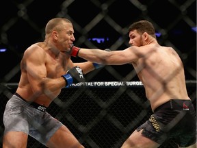 Canadian Georges St-Pierre, left, beat Michael Bisping of England in their UFC middleweight championship bout during the UFC 217 event at Madison Square Garden on Nov. 4, 2017 in New York City.