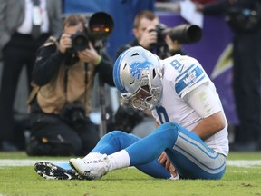 Quarterback Matthew Stafford of the Detroit Lions grabs his hand after being tackled in the fourth quarter against the Baltimore Ravens at M&T Bank Stadium on Dec. 3, 2017 in Baltimore, Maryland.