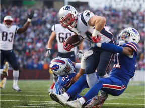 Rex Burkhead #34 of the New England Patriots scores a touchdown as Micah Hyde #23 of the Buffalo Bills and Jordan Poyer #21 of the Buffalo Bills attempt to tackle him during the fourth quarter on December 3, 2017 at New Era Field in Orchard Park, New York.