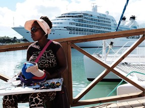 A woman sells jewelry to tourists across from a cruise ship on Dec. 10, 2017 in St John's, Antiqua.