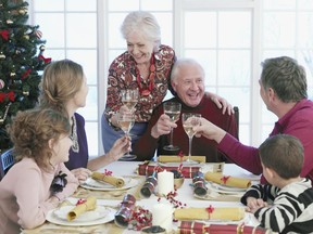 A multi-generation family toasts at Christmas dinner in this photo illustration.

Model and Property Released