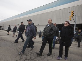 Chrysler workers exit the Windsor Assembly Plant after the morning shift, Thursday, Dec. 21, 2017.
