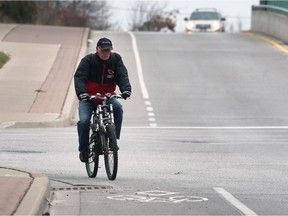 A cyclist uses a biking lane on Monday, December 4, 2017, on Wyandotte Street East near Riverdale Avenue in Windsor.