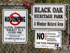 Signs are seen at the Black Oak Heritage Park near the Ojibway Shores woodlot in Windsor on Oct. 24, 2017.