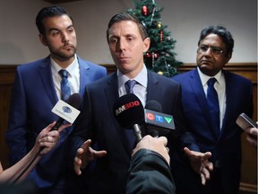 Patrick Brown, centre, leader of the Ontario Progressive Conservative party speaks to reporters at The Windsor-Essex Regional Chamber of Commerce annual general meeting on Thursday, Dec. 7, 2017, at the Caboto Club. Local PC candidates Adam Ibrahim, left, and Mohammad Latif look on.