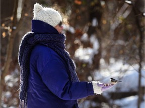 Judith McCullough feeds birds at the Ojibway Nature Centre on a freezing day in Windsor on Dec. 27, 2017.