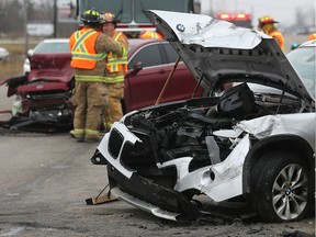 Tecumseh firefighters clean up the scene of a four vehicle collision on Friday, Dec. 22, 2017, at the intersection of Walker Road and Highway 3. Several motorists were taken to hospital with non-life threatening injuries. The crash occurred shortly after noon and shut down the westbound lanes of Highway 3 for about two hours.