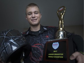 Luke Schwemler, 17, holds his International Hot Rod Association World Championship trophy he won in October on Dec. 18, 2017.