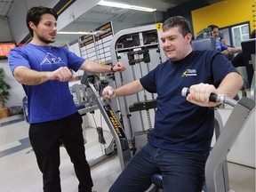 Joe Najem, a University of Windsor kinesiology student, left, works with Kevin Spratt at the St. Denis Centre on Dec. 20, 2017. They are involved in the Fit Together program which provides fitness instruction to individuals with autism spectrum disorder and an intellectual disabilities.