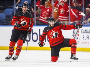 Canada's Taylor Raddysh, centre, celebrates his goal with teammate Conor Timmins during the second period of IIHF World Junior Championship preliminary round hockey action against Finland, in Buffalo, N.Y., Tuesday, December 26, 2017.