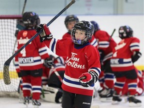 Novice players from the Mooretown Vipers celebrate a victory against the Amherstburg Romano's during the 22nd annual Hockey for Hospice tournament.