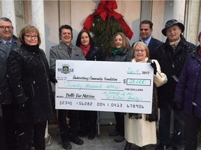 Amherstburg Mayor Aldo DiCarlo and Belle Vue Conservancy¹s Linda Jackson hold a donation cheque presented by sisters Susan and Theresa Whelan who are standing behind the cheque. The donation was made in honour of their late parents, Eugene and Elizabeth Whelan and will see the family name placed below a riverfront window as a major sponsor of the renovation project for the 200-year-old home.