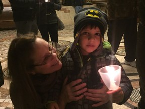 In this file photo from the 2017 candlelight vigil honouring children who'd died, Anthony Zaiden, whose three-year-old brother Adam died from Sudden Unexpected Death Syndrome in 2015, attends the vigil with family friend Rose Bacon.
