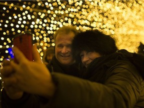 Michelle and Kevin Desmarais take a selfie in a tunnel of lights at the Bright Lights Windsor opening ceremony at Jackson Park, Dec. 8, 2017.