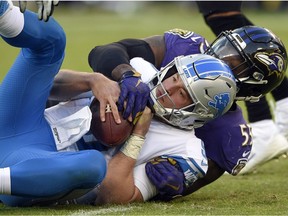 Detroit Lions quarterback Matthew Stafford is sacked by Baltimore Ravens outside linebacker Terrell Suggs in the second half of an NFL football game, Sunday, Dec. 3, 2017, in Baltimore.