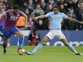 Crystal Palace's Andros Townsend, left, competes for the ball with Manchester City's Ilkay Gundogan during the English Premier League soccer match between Crystal Palace and Manchester City at Selhurst Park in London, Sunday Dec. 31, 2017.