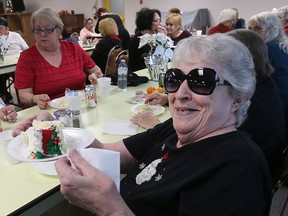 The Feeding Windsor organization has opened a new lunch club inside the 400-unit apartment building at 2455 Rivard Ave. in Windsor. Resident Rose Chichkan gets set to enjoy a piece of cake with her friends on Monday, December 11, 2017, during one of the group-sponsored lunch events.
