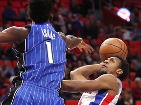 Detroit Pistons guard Ish Smith, right, shoots as Orlando Magic forward Jonathan Isaac (1) defends in the first half of an NBA basketball game in Detroit, Sunday, Dec. 17, 2017.