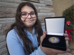 Gabby Wilkinson, 11, displays her Canada 150 award she received for her charitable works, Wednesday, Dec. 20, 2017.