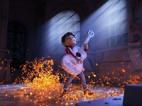 This image released by Disney-Pixar shows characters Miguel, voiced by Anthony Gonzalez in a scene from the animated film, "Coco."