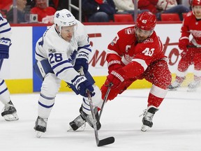 Toronto Maple Leafs right wing Connor Brown (28) battles for the puck with Detroit Red Wings center Henrik Zetterberg (40) in the first period of an NHL hockey game Friday, Dec. 15, 2017, in Detroit.