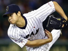 FILE - In this Nov. 19, 2015, file photo, Japan's starter Shohei Otani pitches against South Korea during the first inning of their semifinal game at the Premier12 world baseball tournament at Tokyo Dome in Tokyo.