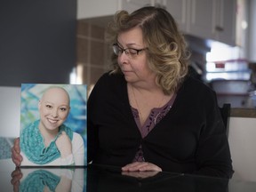 Brenda Roberts, shown Dec. 14, 2017, holds one of the very few photos she has left of her daughter, Kyra Roberts, who died in August. Brenda's van was broken into recently and a jump drive with photos of her daughter was stolen.