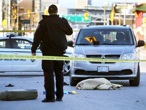 A Windsor Police officer works at the scene of an accident Friday, Dec. 8, 2017. A pedestrian was struck by a minivan at the intersection of Goyeau and Elliot.