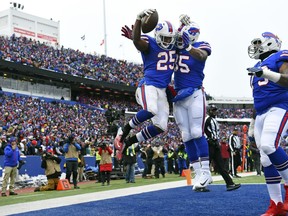 Buffalo Bills running back LeSean McCoy (25) celebrates with teammates Charles Clay (85) and Dion Dawkins (73) after catching a pass for a touchdown during the first half of an NFL football game against the Miami Dolphins, Sunday, Dec. 17, 2017, in Orchard Park, N.Y.