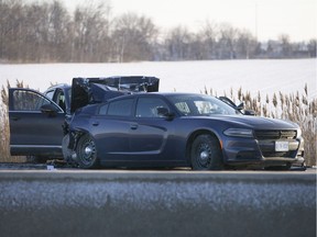 OPP officers investigate a two-car collision involving an OPP cruiser Saturday on Highway 401 west of Tilbury. The crash sent an OPP officer and four others to hospital.