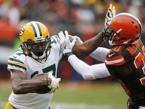 Green Bay Packers wide receiver Davante Adams (17) holds off Cleveland Browns defensive back Jason McCourty (30) in the second half of an NFL football game, Sunday, Dec. 10, 2017, in Cleveland.