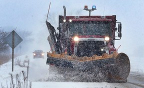 A snowplow leads the way on Little Baseline Road in Lakeshore on Wednesday, Dec. 13, 2017.