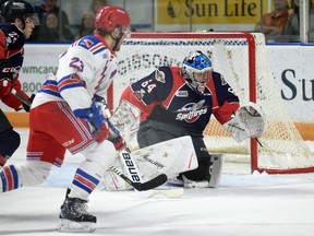 Kitchener Rangers forward Adam Mascherin chases after a rebound from Spitfires goalie Mikey  DiPietro during the first period. He would later score his team's first goal to unleash a tidal wave of teddy bears during teddy bear toss night at the Aud. Tuesday, Photo David BeBee/Record staff