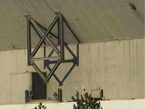 Steel, broken from the explosions, hang from the roof after an attempted implosion of the Silverdome, in Pontiac, Mich.,  Sunday, Dec. 3, 2017. Technical problems with the explosives left the stadium still standing after the blast.