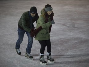 Tiffany Owen gets pushed from Justin Levesque on the opening night of ice skating at Charles Clark Square, Thursday, Dec. 21, 2017.