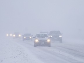 TECUMSEH, ONT:. DEC 24, 2017 -- Vehicles travel along Highway #3 near Sexton Side Road as heavy snow blankets the area, Sunday, Dec. 24, 2017.