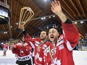 Canada's Pierre-Alexandre Parenteau (left) and Maxim Noreau celebrateafter winning the Spengler Cup in Davos, Switzerland, Sunday, Dec. 31, 2017.
